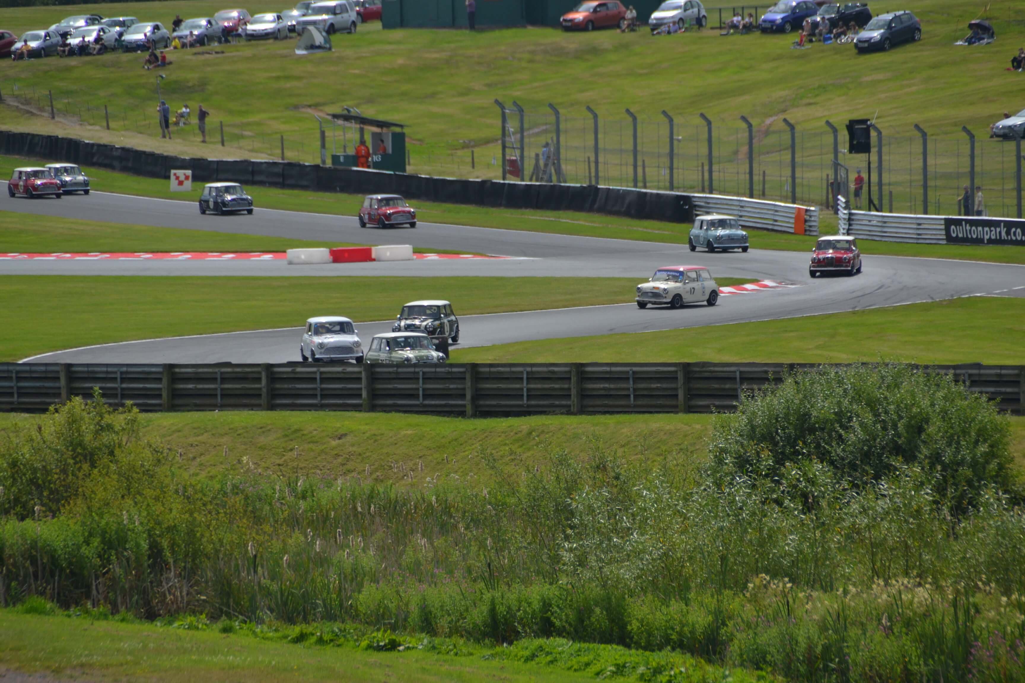 Minis racing around Brands Hatch